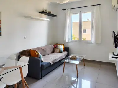 a living room with a couch and a glass table at KYMA Apartments - Athens Acropolis 6 in Athens