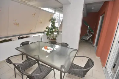 a dining room with a table and chairs at A&J Apartments or Rooms athens airport in Markopoulo