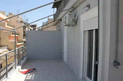 an empty alley with a white wall on a building at Apartment in the Centre of Athens in Athens