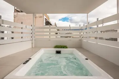 a bath tub in the middle of a room at Syntagma Spa with Acropolis View in Athens