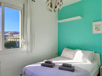 a bedroom with a bed with two towels on it at KYMA Apartments - Athens Acropolis 3 in Athens