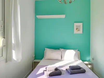 a bedroom with blue walls and a bed with two pillows at KYMA Apartments - Athens Acropolis 3 in Athens