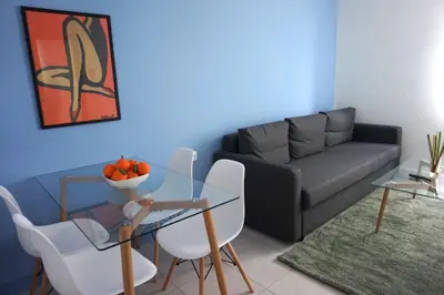 a living room with a couch and a table and chairs at KYMA Apartments - Athens Acropolis 3 in Athens