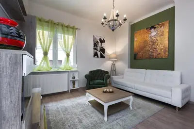 a living room with a white couch and a table at Vintage Apartment in the Heart of Plaka in Athens