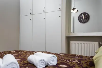 a bed with towels sitting on top of it at Vintage Apartment in the Heart of Plaka in Athens
