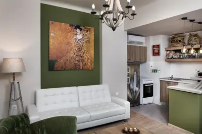 a living room with a white couch and a kitchen at Vintage Apartment in the Heart of Plaka in Athens