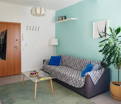 a living room with a couch and a table at KYMA Apartments - Athens Acropolis 4 in Athens