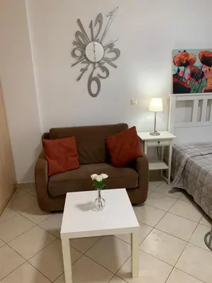 a living room with a couch and a table at Glyfada Centre Studio in Athens