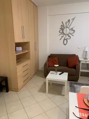a living room with a couch and a table at Glyfada Centre Studio in Athens