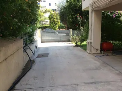 a driveway with a gate in a house at Glyfada Centre Studio in Athens