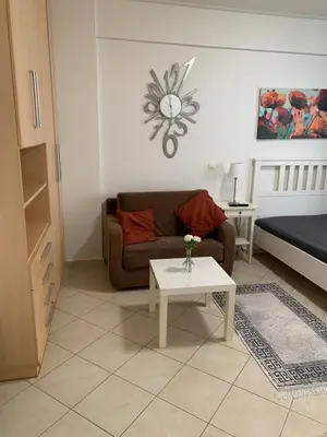 a living room with a couch and a table at Glyfada Centre Studio in Athens