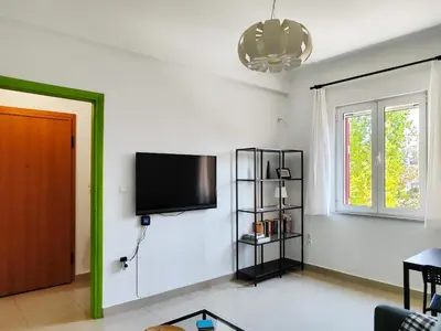 a living room with a flat screen tv on a wall at KYMA Apartments - Athens Acropolis 1 in Athens