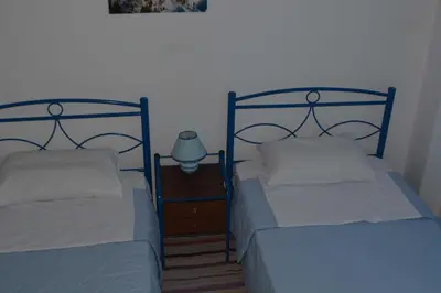 two beds sitting next to each other in a room at Cosy Apartment Pinotsi in Athens