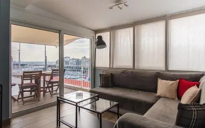 a living room with a couch and a table at Piraeus Apartment with Endless View in Piraeus