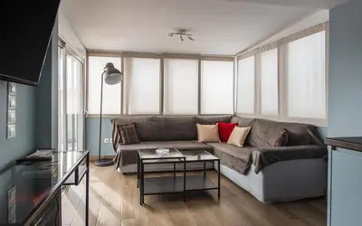 a living room with a couch and a table at Piraeus Apartment with Endless View in Piraeus