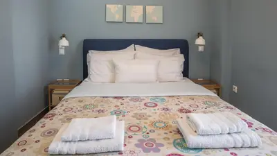a bedroom with a bed with two towels on it at Piraeus Apartment with Endless View in Piraeus