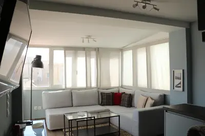 a white couch in a living room with windows at Piraeus Apartment with Endless View in Piraeus