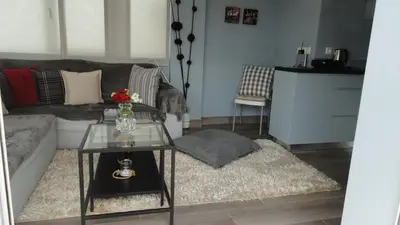 a living room with a couch and a table at Piraeus Apartment with Endless View in Piraeus