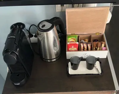 a kitchen counter with a coffee maker and a tea kettle at Piraeus Apartment with Endless View in Piraeus