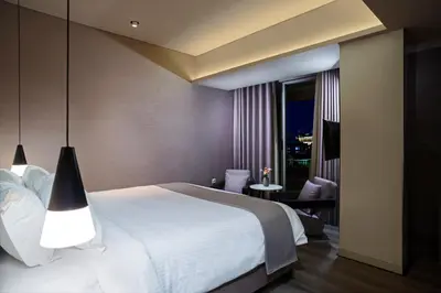 a bedroom with a large white bed and a window at Hotel Lozenge in Athens