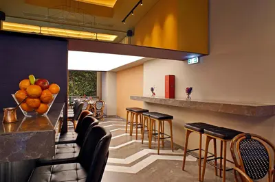 a bar in a restaurant with stools at Hotel Lozenge in Athens