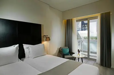 a hotel room with a bed and a window at Hotel Lozenge in Athens