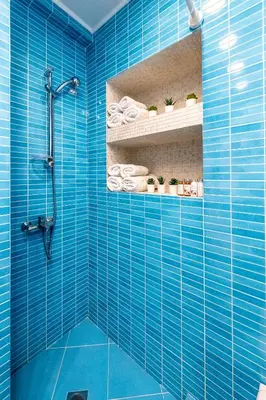 a blue bathroom with a shower with blue tiles at Hidesign Athens Plaka Apartment in Acropolis in Athens