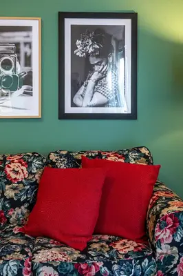 a couch with two red pillows in a living room at Hidesign Athens Plaka Apartment in Acropolis in Athens