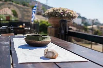 a bowl sitting on top of a wooden table at Four Seasons Stonework Castle in Lagonissi