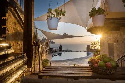 a basket of fruit on a balcony with a pool at Four Seasons Stonework Castle in Lagonissi