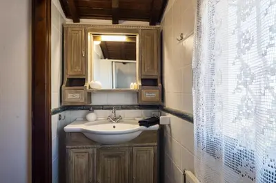 a bathroom with a sink and a mirror at Four Seasons Stonework Castle in Lagonissi