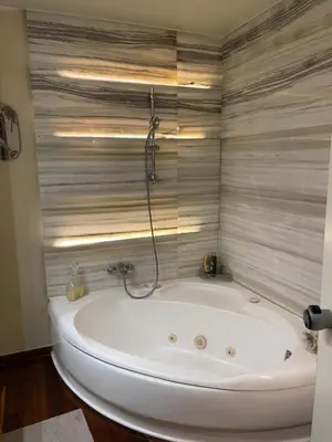 a white bath tub in a bathroom with a shower at Athens Lycabettus Hill Penthouse, Private Roof Garden & Pool in Athens