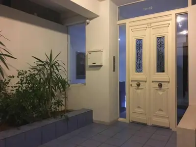 a white door in the side of a building at Athens Lycabettus Hill Penthouse, Private Roof Garden & Pool in Athens