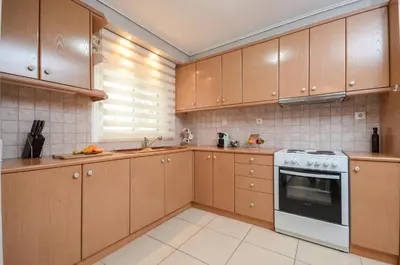 a kitchen with wooden cabinets and a stove at Boutique Apartments in Athens in Athens