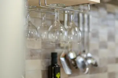 a bunch of wine glasses hanging on a wall at Boutique Apartments in Athens in Athens