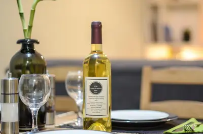 a bottle of wine sitting on a table with glasses at Boutique Apartments in Athens in Athens