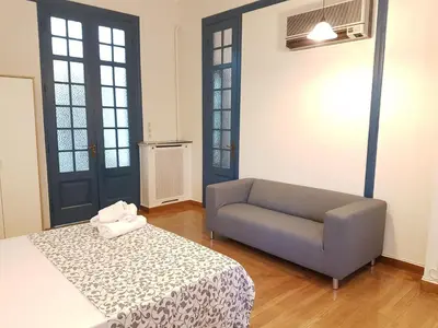 a living room with a couch and a chair at Errathens Aegean Apartment - Athens Center, 5 BD, 2 BATH in Athens