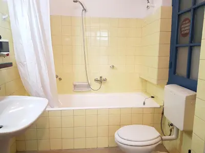 a bathroom with a toilet and a tub and a sink at Errathens Aegean Apartment - Athens Center, 5 BD, 2 BATH in Athens
