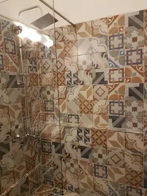 a bathroom with a shower with mosaic tiles at Errathens Aegean Apartment - Athens Center, 5 BD, 2 BATH in Athens