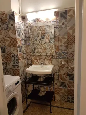 a bathroom with a sink and a washing machine at Errathens Aegean Apartment - Athens Center, 5 BD, 2 BATH in Athens