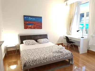 a bedroom with a bed and a desk and a desk at Errathens Aegean Apartment - Athens Center, 5 BD, 2 BATH in Athens