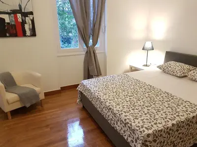 a bedroom with a bed and a chair and a window at Errathens Aegean Apartment - Athens Center, 5 BD, 2 BATH in Athens