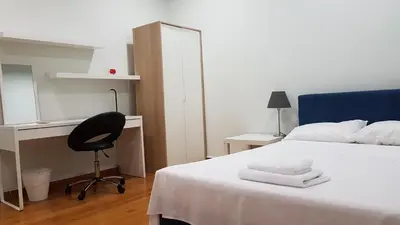a bedroom with a bed and a desk and a chair at Errathens Pine Red and Taupe - Athens Center in Athens