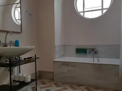 a bathroom with a sink and a bath tub at Errathens Pine Red and Taupe - Athens Center in Athens
