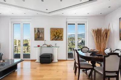 a dining room with a table and chairs at Acropolis Elegant Penthouse in Athens