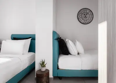 a bedroom with a bed and a clock on the wall at Acropolis Elegant Penthouse in Athens