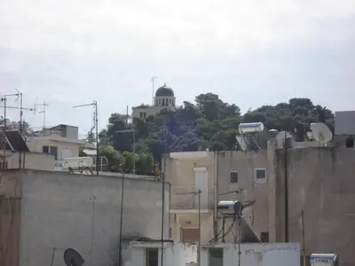 a building on top of a hill with a building at Soho Athene Apartment in Athens