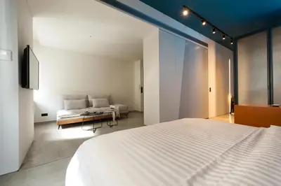 a bedroom with a white bed and a couch at Syntagma Square Modern Apartments in Athens