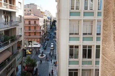 a view of a street between two buildings at Syntagma Square Modern Apartments in Athens