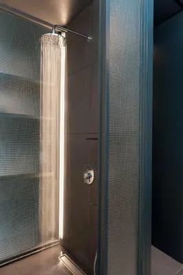 a shower with a curtain in a bathroom at Syntagma Square Modern Apartments in Athens